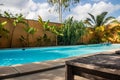 Swimming pool in tropical paradise with palm trees around and crystal clear blue water, perfect touristic destination Royalty Free Stock Photo