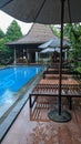 swimming pool view with classic Javanese joglo with rainy atmosphere Royalty Free Stock Photo