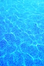 Swimming pool water background. Summer backdrop with blue shiny water with sun highlights in the pool