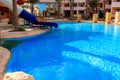 Swimming pool with water slide at tropic summer resort Royalty Free Stock Photo