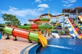 Swimming pool with water slides in aqua park on sunny day. summer fun activity, vacation leisure concept