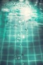 Swimming pool water surface with bubbles and ripples in transparent turquoise water with net pattern in vintage style Royalty Free Stock Photo