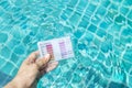 Swimming pool water testing test kit in girl hand Royalty Free Stock Photo