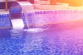 Swimming pool with waterfall jet Royalty Free Stock Photo