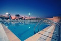 Swimming Pool with waterside during twilight