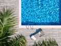 Swimming pool with wooden deck and chaise lounge Royalty Free Stock Photo