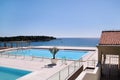 Swimming pools of luxury holiday hotel, amazing nature view landscape sea. Relax near two swimming pools with handrail. Royalty Free Stock Photo