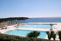 Swimming pools of luxury holiday hotel, amazing nature view landscape sea. Relax near two swimming pools with handrail. Royalty Free Stock Photo