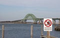 Swimming prohibited sign with the Robert Moses Bridge in the background over the inlet Royalty Free Stock Photo