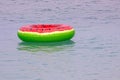 swimming ring with a watermelon pattern on the surface of the water in the sea