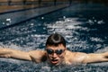 Swimming sports athlete swimmer swims in the pool, preparing for the race. Professional men& x27;s water sports for adults Royalty Free Stock Photo