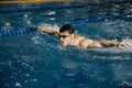 Swimming sports athlete swimmer swims in the pool, preparing for the race. Professional men& x27;s water sports for adults Royalty Free Stock Photo
