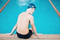 Swimming, sports and portrait of happy man by pool for training, competition and exercise in gym. Professional, fitness Royalty Free Stock Photo