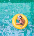 Swimming, summer vacation - child boy playing in blue wat