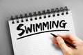 Swimming text on notepad, concept background Royalty Free Stock Photo