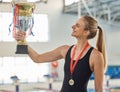Swimming, trophy and winner in celebration with medal, achievement or happiness from success in the race or pool Royalty Free Stock Photo