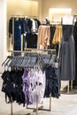 Swimming trunks and dresses are displayed in a bright and large shop