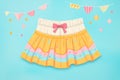 swimwear with skirt portion on a pastel backdrop Royalty Free Stock Photo
