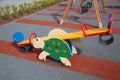 Swing bright color in the form of a turtle on the Playground with rubberized surface.