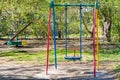 A swing, a carousel, a slide from metal painted with colorful paint