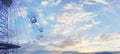 Swing chain carousel in amusement park against sky clouds background