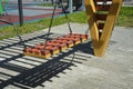 Swing on chains in the city park. children`s playground Royalty Free Stock Photo