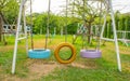 Swing chairs made from old tires for children in park. Royalty Free Stock Photo