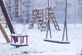 Swing for children in winter. playground near the house Royalty Free Stock Photo