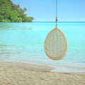 Swing hang on tree over beautiful beach in Thailand