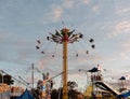 Swing Ride and Amusements on the Midway at a County Fair