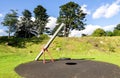 A swing with a rubber round seat hanging on four chains in Duthie park playground, Aberdeen Royalty Free Stock Photo