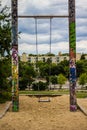 Swing in sandbox on playground with graffiti Royalty Free Stock Photo