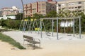 Swing Set and Bench in Serene City Park Royalty Free Stock Photo