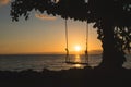 A swing silhouette at sunset by the sea, beautiful colors, Thailand Royalty Free Stock Photo