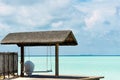 Swing on a tropical beach. isolated idyllic island with boats in the background