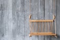 Swing wooden chair on old concrete wall texture Royalty Free Stock Photo