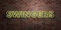 SWINGERS - fluorescent Neon tube Sign on brickwork - Front view - 3D rendered royalty free stock picture Royalty Free Stock Photo