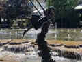 Swinging over the fountain Royalty Free Stock Photo