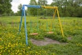 Swings for children, empty, yellow-blue Royalty Free Stock Photo