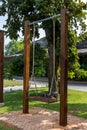 The swings hung below the brick floor. Children playground ayunan swing hanging in park garden. blank white wooden swing in flower Royalty Free Stock Photo