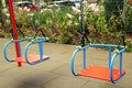 Swings on outdoor playground in residential area Royalty Free Stock Photo