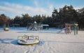 Swings at the playground covered with snow in winter time. Royalty Free Stock Photo