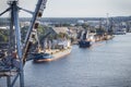 Swinoujscie, West Pomeranian - Poland - July 13, 2022: View from lighthouse in Swinoujscie on large cranes and ships in port