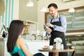 Swiping credit card in a coffee shop Royalty Free Stock Photo