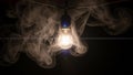 Swirl around the bulb illuminated by its light creating a dramatic Royalty Free Stock Photo