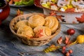 Swirl buns on wicker basket with autumn decoration Royalty Free Stock Photo