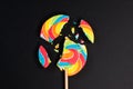 Swirl round broken lollipop on black background.