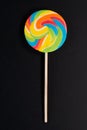 Swirl round lollipop on black background.