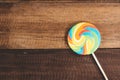 Swirl round lollipop on wooden table background.
