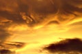 Swirled yellow and black clouds at sunset